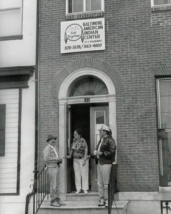 Lumber people (L - R Johnny Lee, Margie Chavis, and two others) stand on the stoop of the Baltimore American Indian Center