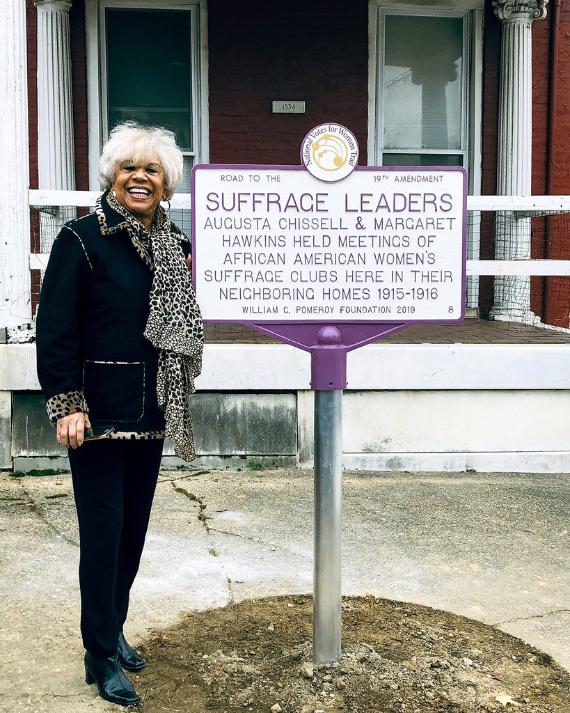 Chissell’s great niece Carolyn Chissell standing beside the marker dedicated to Chissell and Margaret Hawkins at 1534 Druid Hill Ave