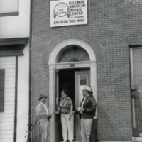 Lumber people (L - R Johnny Lee, Margie Chavis, and two others) stand on the stoop of the Baltimore American Indian Center